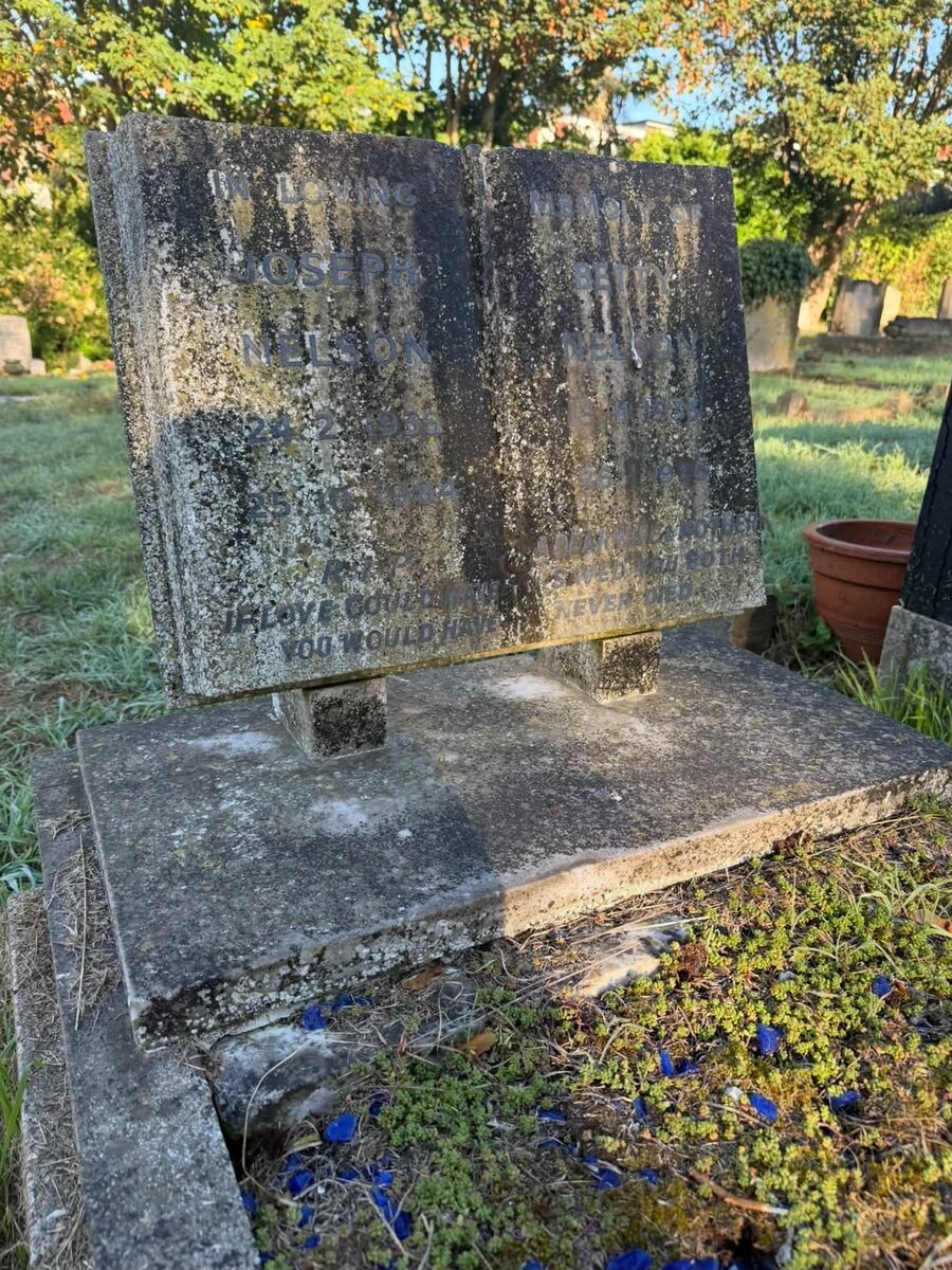 Open-book headstone before cleaning