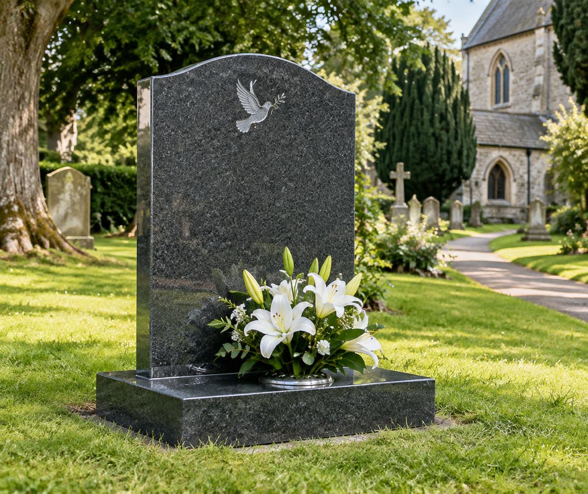 A polished granite memorial with white lilies in a Sussex churchyard
